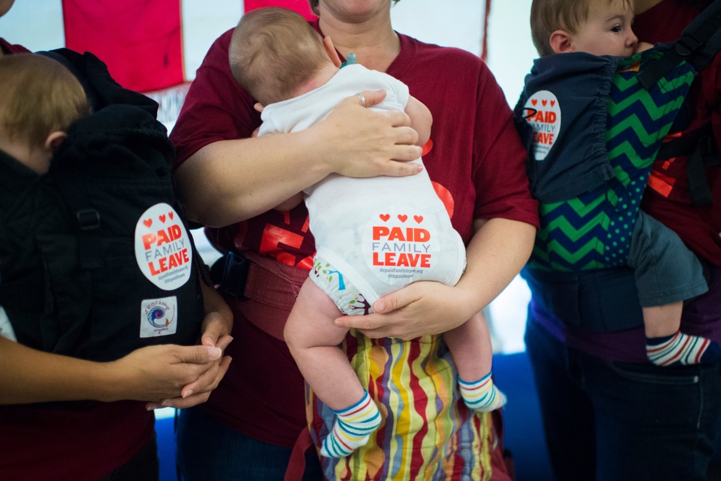 Babies with 'paid family leave' stickers