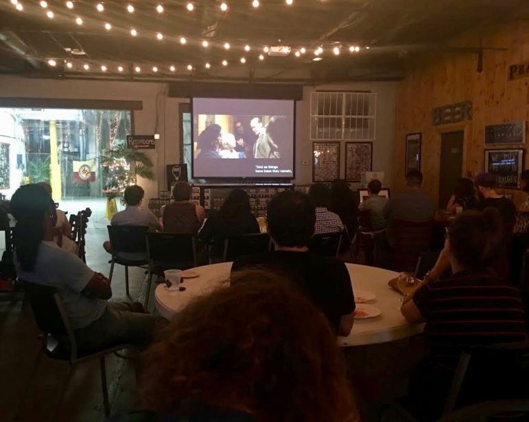 A group in a resturant watching a film