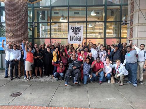 group of people protesting that "one job should be enough"