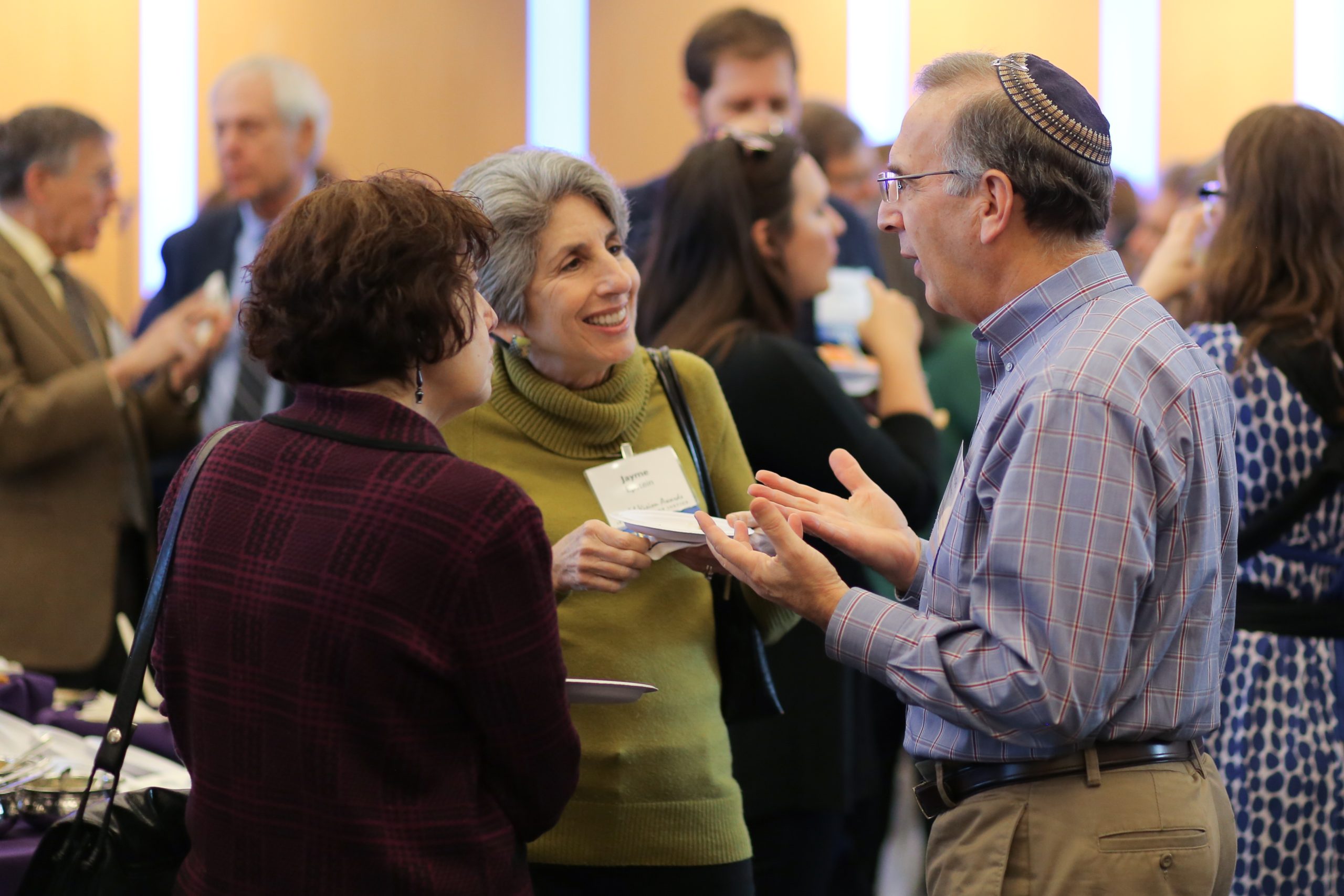 JUFJ leaders discussing at an event, among them Jayme Epstein