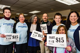 signing-for-15-2 JUFJ leaders pose with signs that read "Fight for $15"