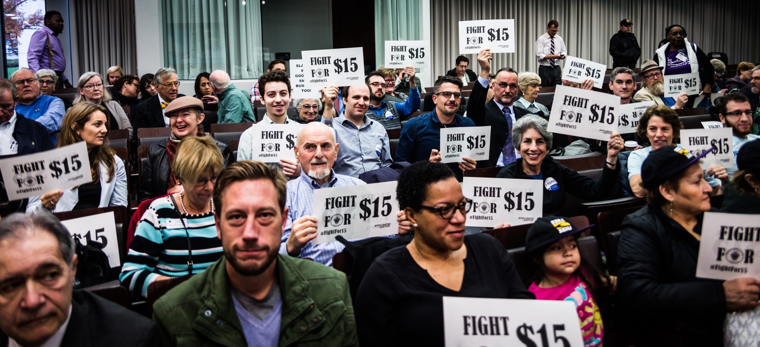 fight for 15 activists holding signs