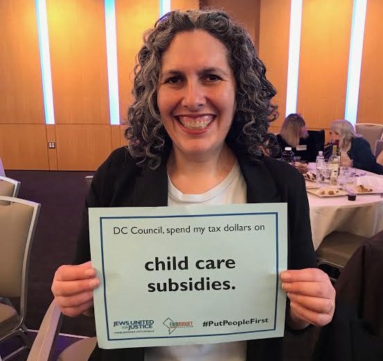 rabbi elizabeth holding a sign