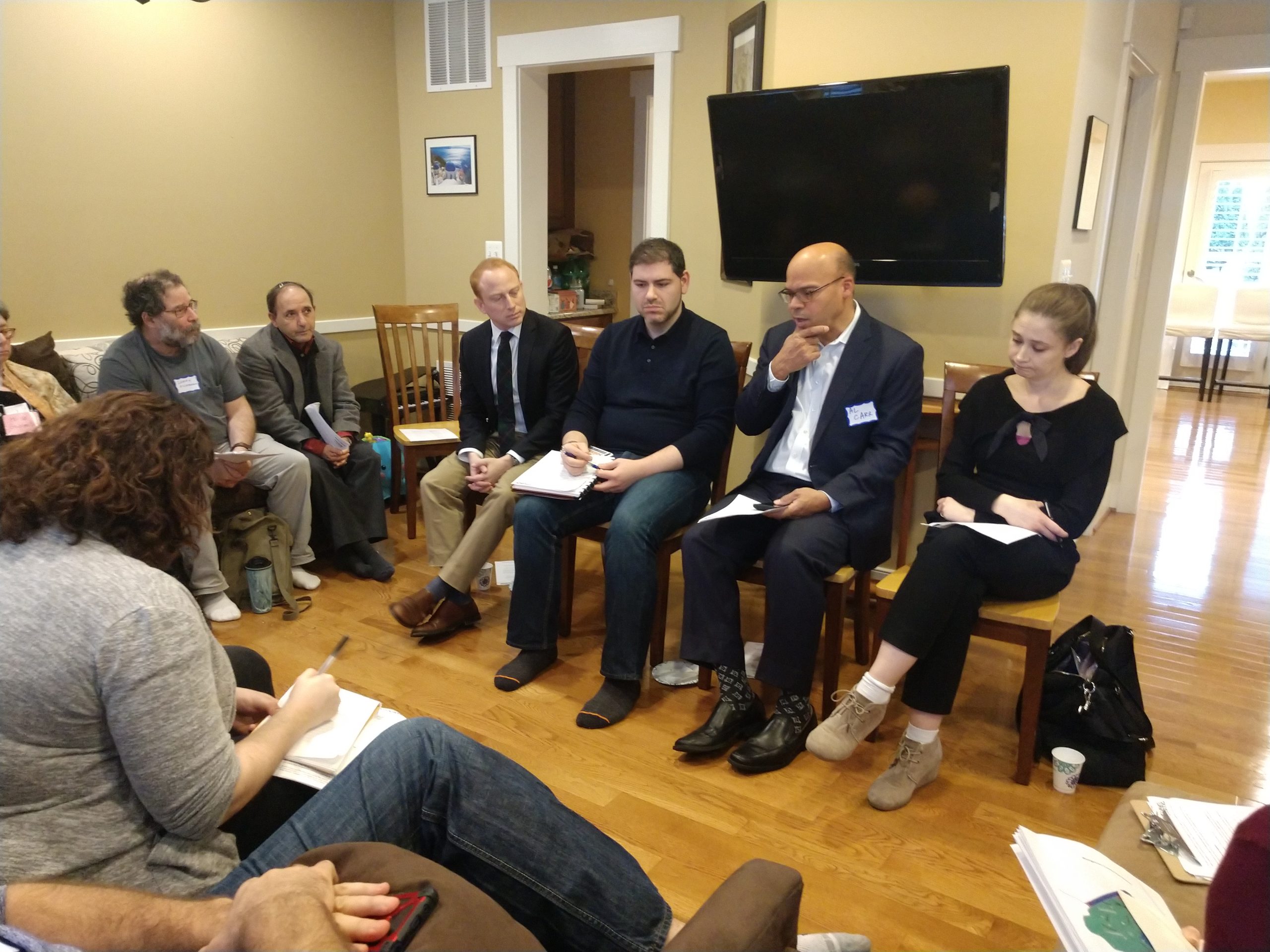people sit in a circle during district 18 legislator meeting