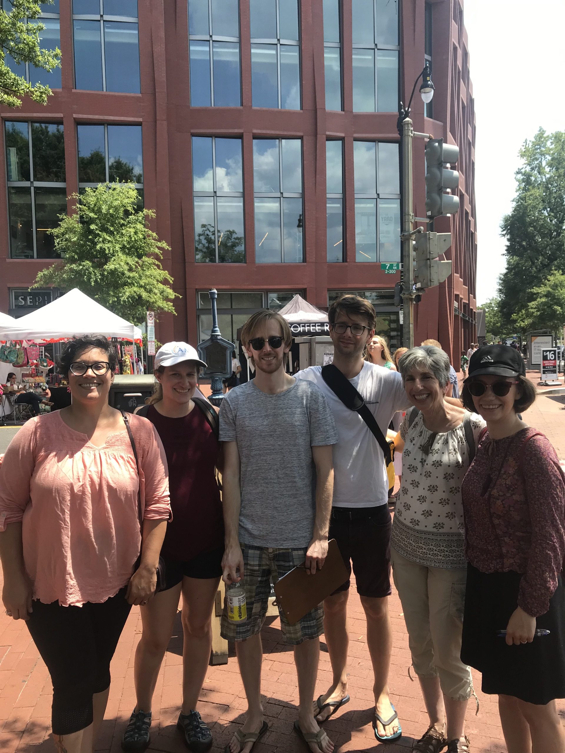 people pose for a photo at a street fair