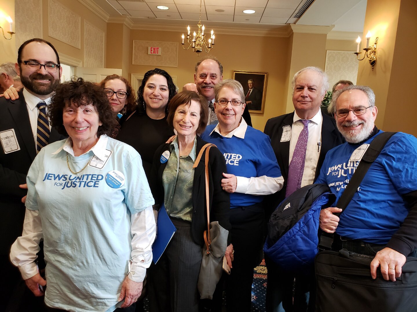 people pose for a photo during trust act hearing