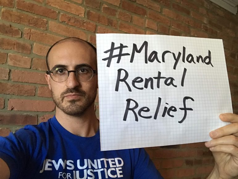 Dan Richman holds a sign: #MarylandRentalRelief
