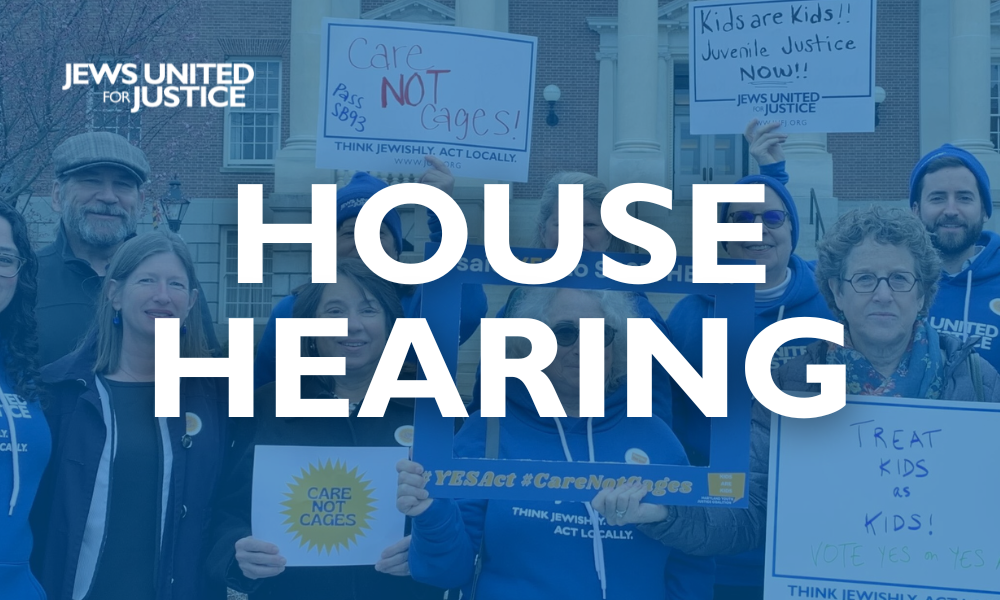 Photo of people with signs and text that says House Hearing
