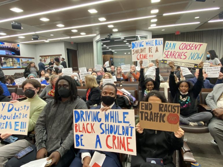 People holding signs in support of the Freedom to Leave Act