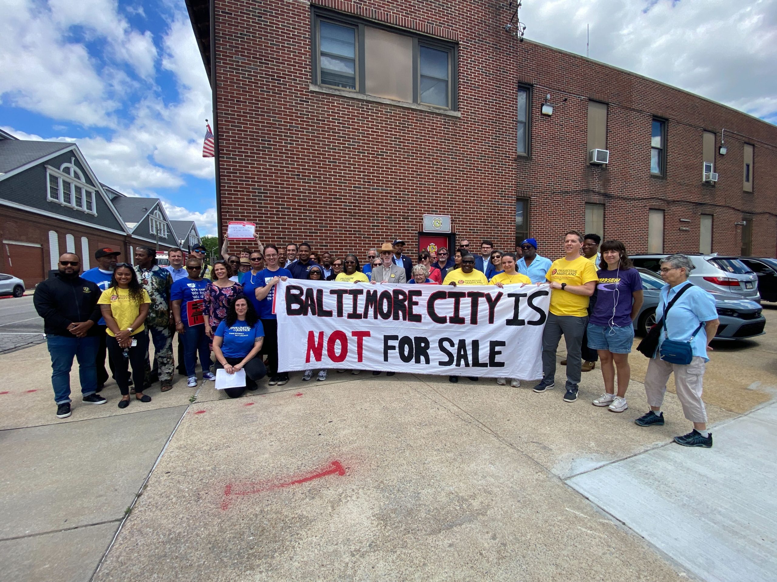 Photo of a group of Baltimore City Not for Sale Canvassers holding a sign that says 